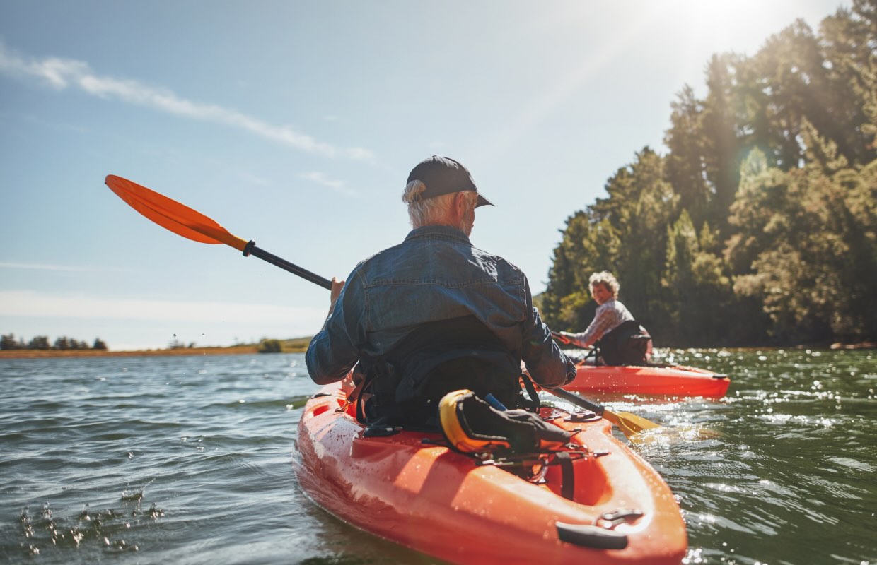 Older couple kayaking in lake