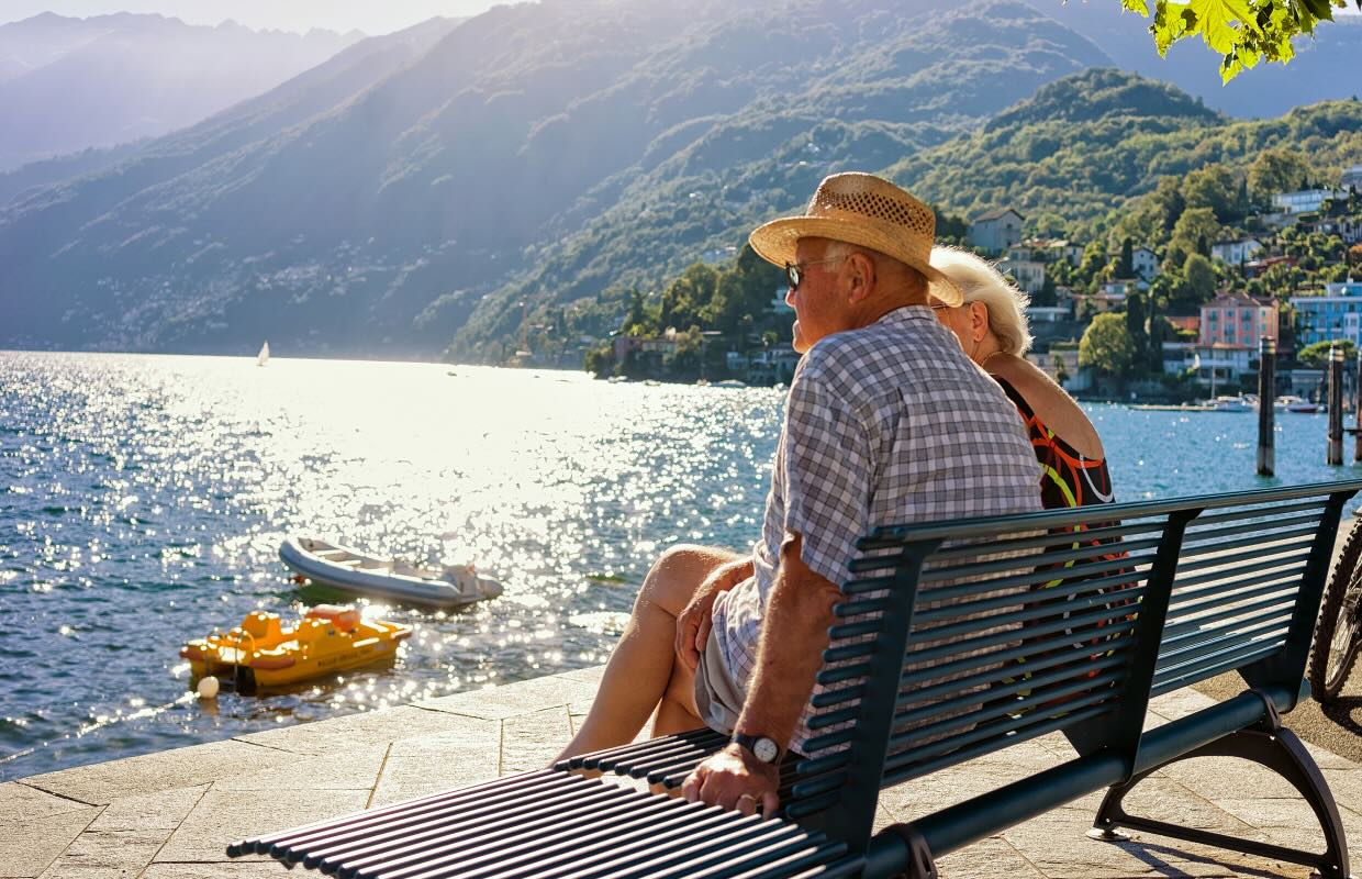 Retired Couple sits on seaside bench